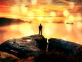 Hiker watching to autumn Sun at horizon . Beautiful moment the miracle of nature. Colorful mist in valley. Man stands alone Royalty Free Stock Photo