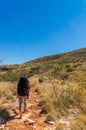 Hiker on the way to the top of Mount Sonder just outside Alice Springs in central Australia, West MacDonnel National Park, Royalty Free Stock Photo