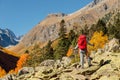 Hiker woman with backpack enjoying view in the autumnal mountains. Rocky mountains and tourist Royalty Free Stock Photo
