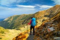 Hiker woman with backpack in Fagaras mountains, Transylvania, Romania, Europe