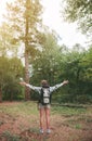 Hiker woman with backpack raising her arms into Royalty Free Stock Photo