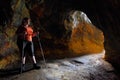 Hiker woman explore ancient underground mine. Royalty Free Stock Photo