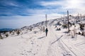 Hiker woman goes in winter in mountains through beautiful landscape in sunny day, poland beskide Royalty Free Stock Photo