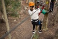 Hiker woman going down a zip line in the forest Royalty Free Stock Photo