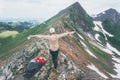 Hiker woman happy hands raised on mountain summit Travel Lifestyle adventure concept summer vacations outdoor exploring wild Royalty Free Stock Photo