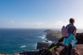 Sao Lourenco - Hiker woman looking at majestic Atlantic Ocean coastline at Ponta de Sao Lourenco peninsula, Canical