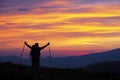 Hiker woman with raised arms on the mountain top Royalty Free Stock Photo