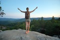 Hiker woman relaxing on mountain footpath raising up hands enjoying evening nature during travel on wilderness trail Royalty Free Stock Photo