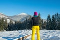 Hiker woman resting in the winter wood and enjoys views. Royalty Free Stock Photo