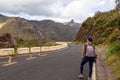 Hiker woman standing on curvy remote car road and view on mountain Roque de Taborno in Anaga massif on Tenerife, Canary Islands Royalty Free Stock Photo
