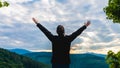 Hiker woman standing with hands up achieving the top