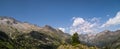 Cinemascope or vistarama vision of hiker woman on top of a mountain watching mountainous landscape of Pyrenees Royalty Free Stock Photo