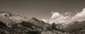 Hiker woman on top of a mountain watching mountainous landscape of Pyrenees in black and white Royalty Free Stock Photo