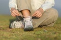 Hiker woman tying shoelaces of boots Royalty Free Stock Photo