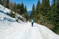 Dreilaendereck - Hiker woman walking on snow covered meadow at idyllic Dreilaendereck, Karawanks, Carinthia