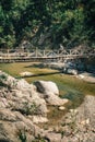 Hiker on the wooden bridge over mountain river in Turkey