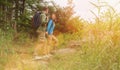 Hiker young couple walking in summer forest