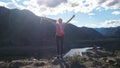 Hiker young happy woman standing on top of a mountain with hands rised up. Royalty Free Stock Photo