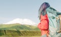 Hiker young woman with backpack looking at mountain Elbrus. Royalty Free Stock Photo