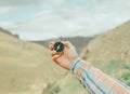 Woman searching direction with a compass in mountains, pov. Royalty Free Stock Photo