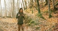 Hiker young woman walking in autumn forest Royalty Free Stock Photo