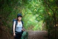 Hiker young women walking in national park outdoors with backpack. Woman tourist going camping in forest.