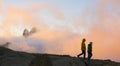 Hikers in the Anayet lakes with the Midi d Ossau mountain in the clouds, Pyrenees of Huesca Royalty Free Stock Photo