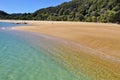 Hikers on the Anchorage beach in Abel Tasman National Park.