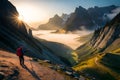 Hikers ascending a steep, rocky incline, with sheer cliffs on one side and a vast valley on the other, shrouded in morning mist