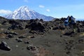 Hikers on ash and black lava close to Tolbachik volcano in the far east peninsula of Kamchatka in Russia