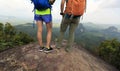 Hikers with backpack enjoy the view on mountain peak