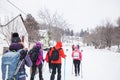 Hikers with backpack hiking on snowy trail. Group of people walking together at winter day Royalty Free Stock Photo