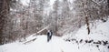 Hikers with backpack hiking on snowy trail. Group of people walking together at winter day. Back view Royalty Free Stock Photo