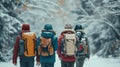 Hikers with backpack hiking on snowy trail. Group of people walking together at winter day. Back view Royalty Free Stock Photo