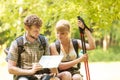 Hikers backpackers couple reading map on trip. Royalty Free Stock Photo