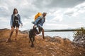 Hikers with backpacks and their doberman walking enjoying at the mountain lake