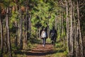 Hikers with backpacks walking trough forest path Royalty Free Stock Photo