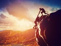 Hikers climbing on rock, giving hand and helping to climb Royalty Free Stock Photo