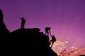 Hikers Climbing On Rock, Mountain At Sunset, One Of Them Giving Hand And Helping To Climb.Teamwork , Helps ,Success, Winner And Le
