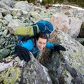 Hikers are climbing rocky slope of mountain