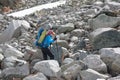 Hikers are climbing rocky slope of mountain