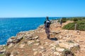 Hikers on a coastal path by the sea in Menorca, Balearic islands Spain