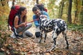 Hikers couple in love cuddling their dog Royalty Free Stock Photo
