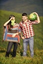Hikers couple in love. Man bring watermelon for picnic in mountains. Summer vacation. Pleasant hike picnic. Fruits Royalty Free Stock Photo