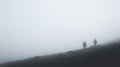 Hikers at distance during a strong blizzard