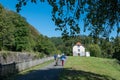Hikers with dog at lock keeper house No 2 in the lock keepers valley Vallee des eclusiers