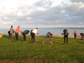 Hikers doing warm-up movement on Pointe du Roselier in Plerin