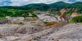 Hikers at fumarolic field at the Mendeleev volcano at Kunashir island, Russia Royalty Free Stock Photo