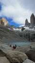 Hikers at glacier lake below Torres del Paine formation