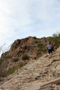 Hikers going up the rocky Piestewa Summit Trail in the mountains of Phoenix, Arizona